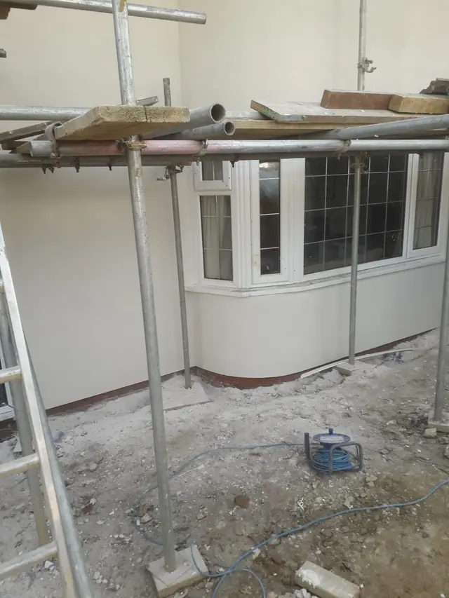 Newly rendered bay window and walls behind scaffolding on an exterior plastering job in High Wycombe