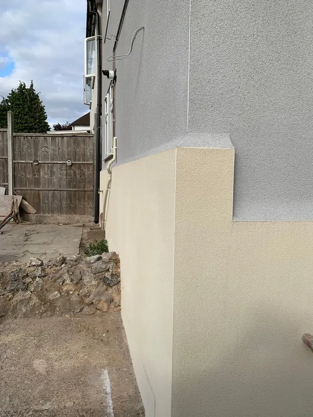 Side wall of a house in Wooburn Green with a new monocouche render, cream below and grey above