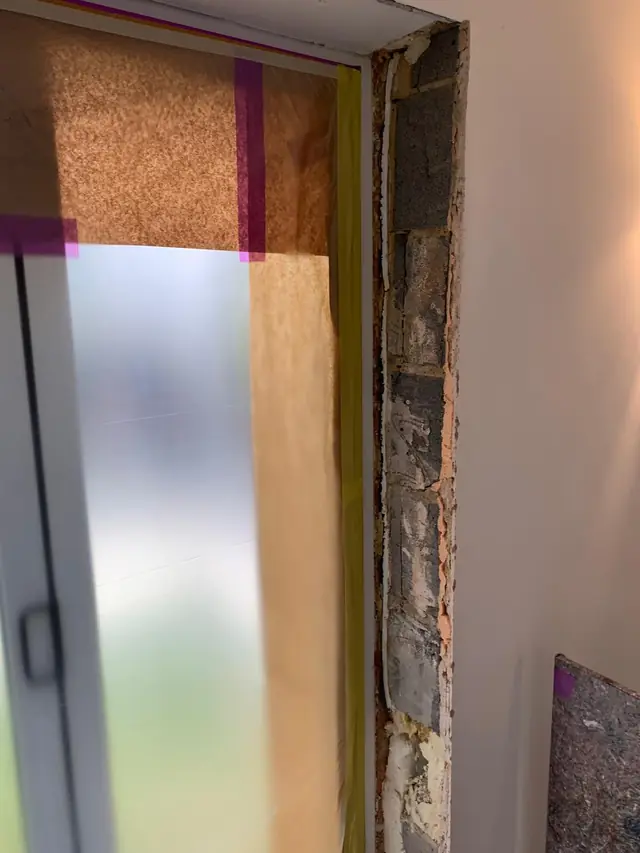 Window reveal in Hazlemere cut back to the blockwork and taped up, ready for a plaster patch repair