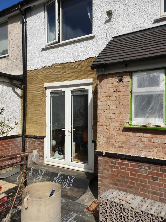 Scratch coat over the brickwork at the back of a house in Beaconsfield, ready for pebble dashing