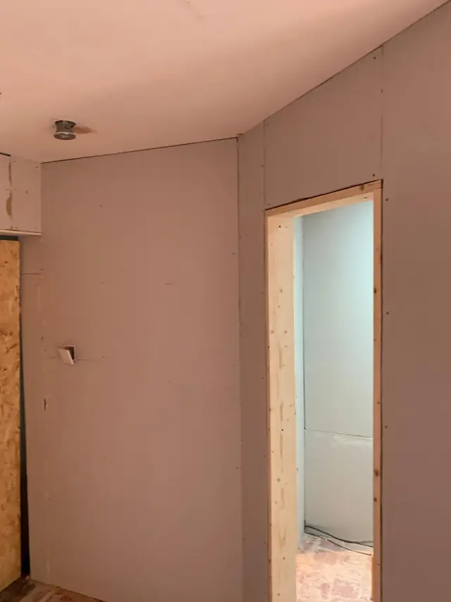 Newly plasterboarded room in Little Chalfont, with a doorway through to a second boarded room