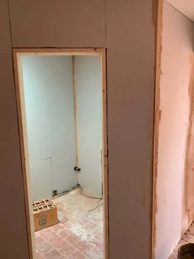 Plasterboarded walls around a new doorway in Little Chalfont, with the board joints filled ready for skimming